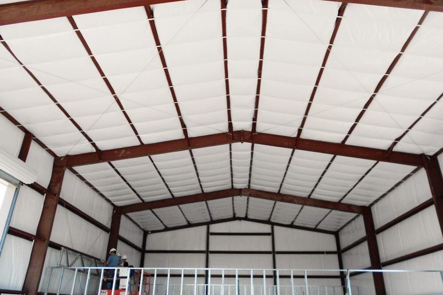 Butler Long-Tab Banded insulation system installed in commercial metal building roof showing filled purlin cavity and banding support