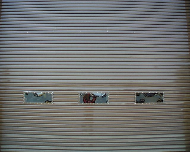 Butler Tereza Series 200 Original Sheet Door component detail — [drum assembly / weather seal / lock assembly / guide rail / chain operation / curtain section / full door view] (assign each to the appropriate detail based on order)