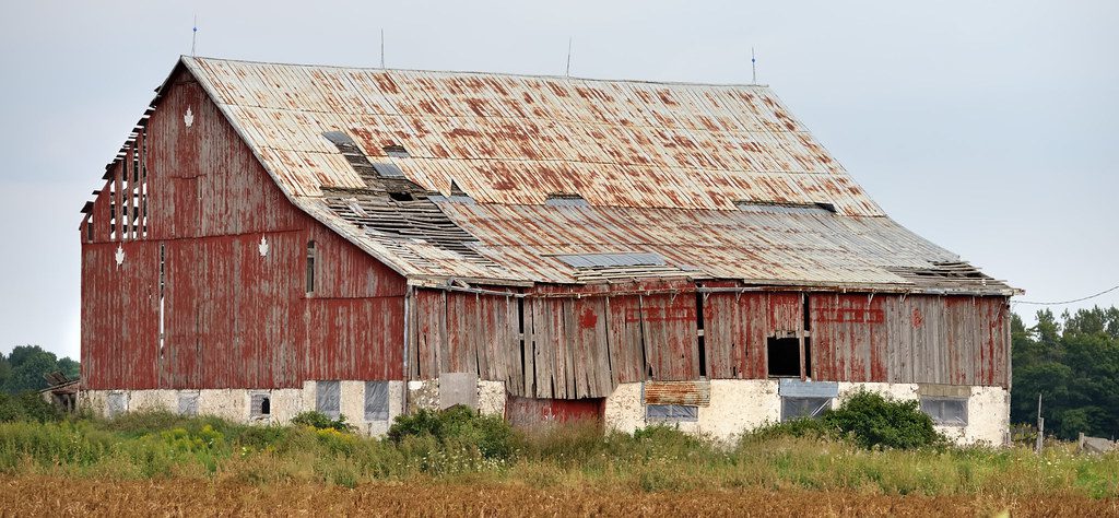 Butler metal building before field repair showing damaged corroded or deteriorated roof panels wall panels or trim requiring professional restoration