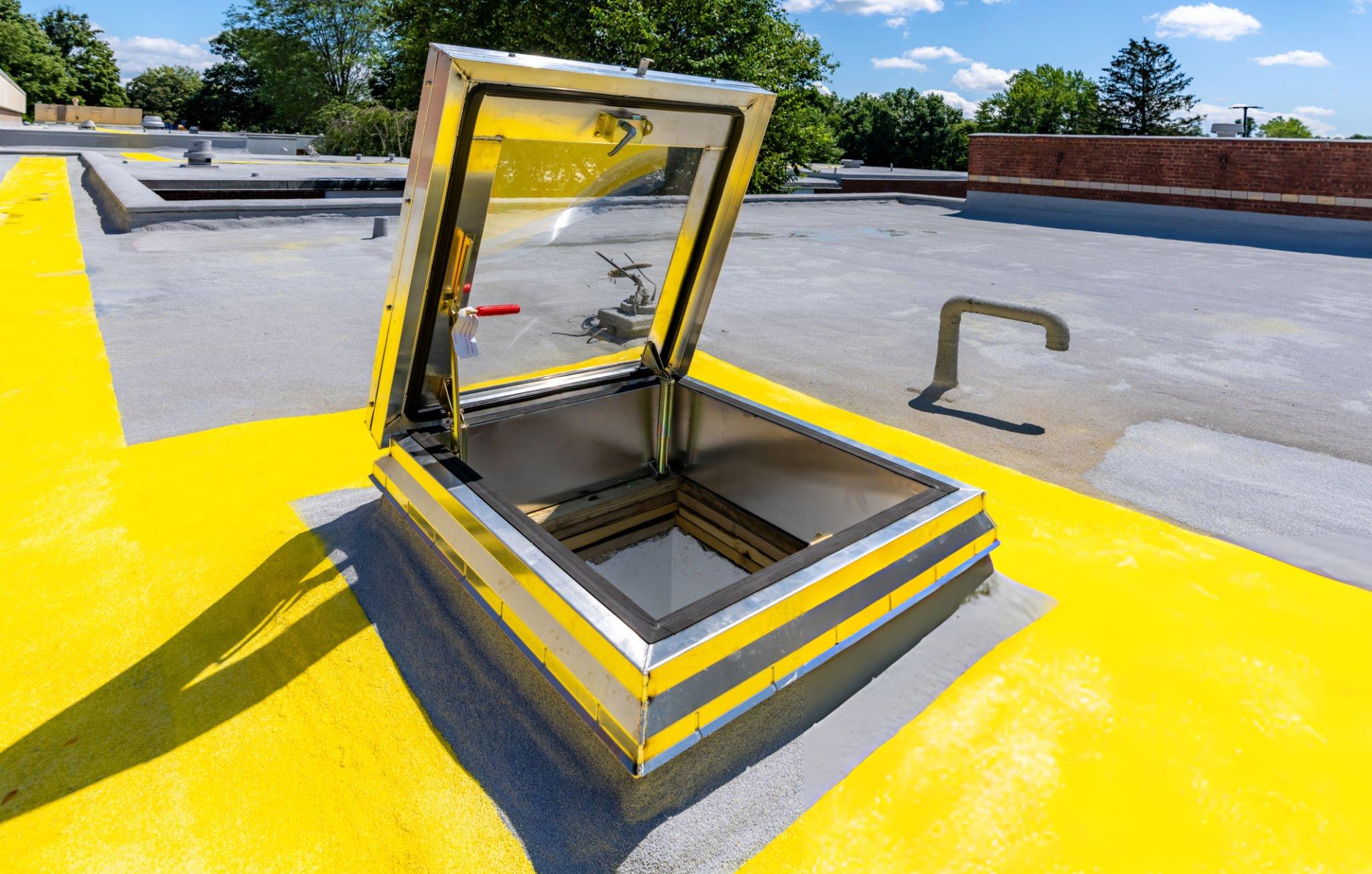 Butler Building access hatch installed on metal roof with OSHA-compliant safety railing