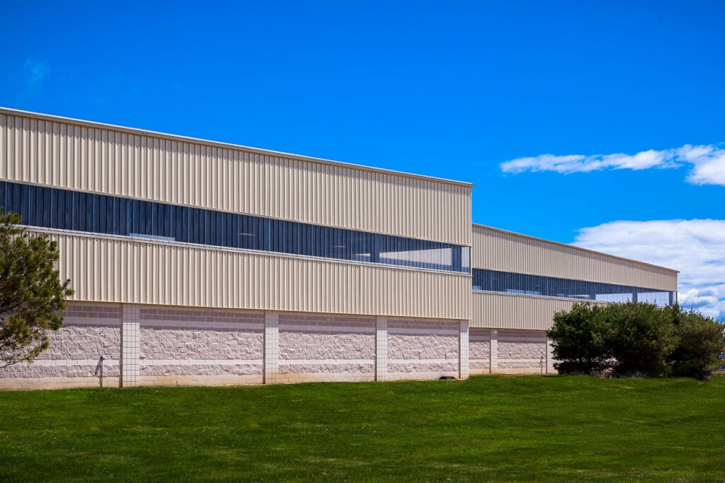 California property owner contractor or developer reviewing Butler building pre-construction plan including site survey drawings permit documents and construction timeline for a new commercial warehouse industrial facility or agricultural building project