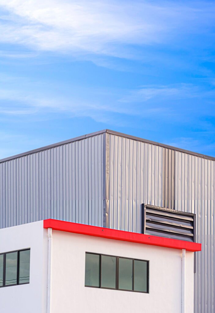 Completed Butler metal wall panel re-skin on a commercial building showing new OEM Butlerib II or Shadowall wall panels with fresh Butler-Cote finish installed over existing Butler girt framing for long-term structural performance and weather resistance