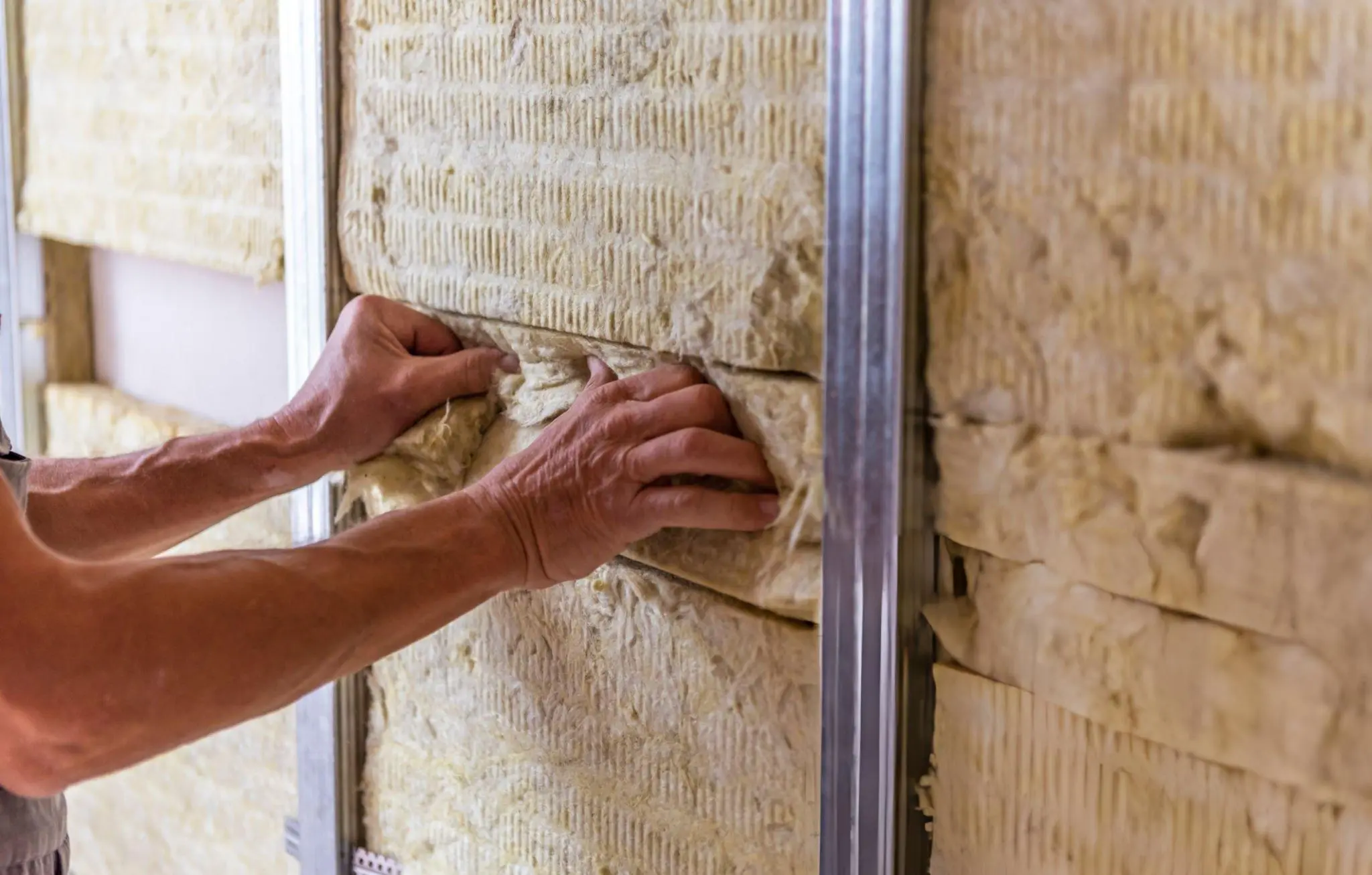 Butler Building wall insulation system installed in a commercial metal building wall assembly showing vapor retarder facing fiberglass batt insulation and metal wall panel layers for thermal performance and moisture control